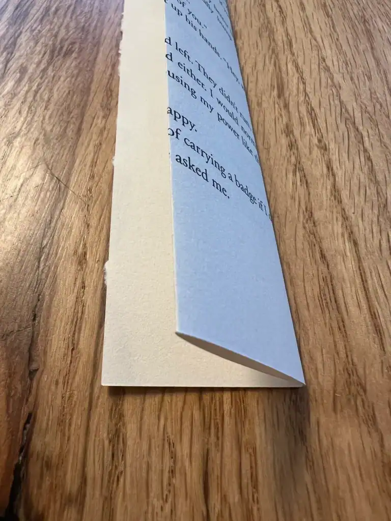 Folding a book page in half lengthwise for a book page wreath