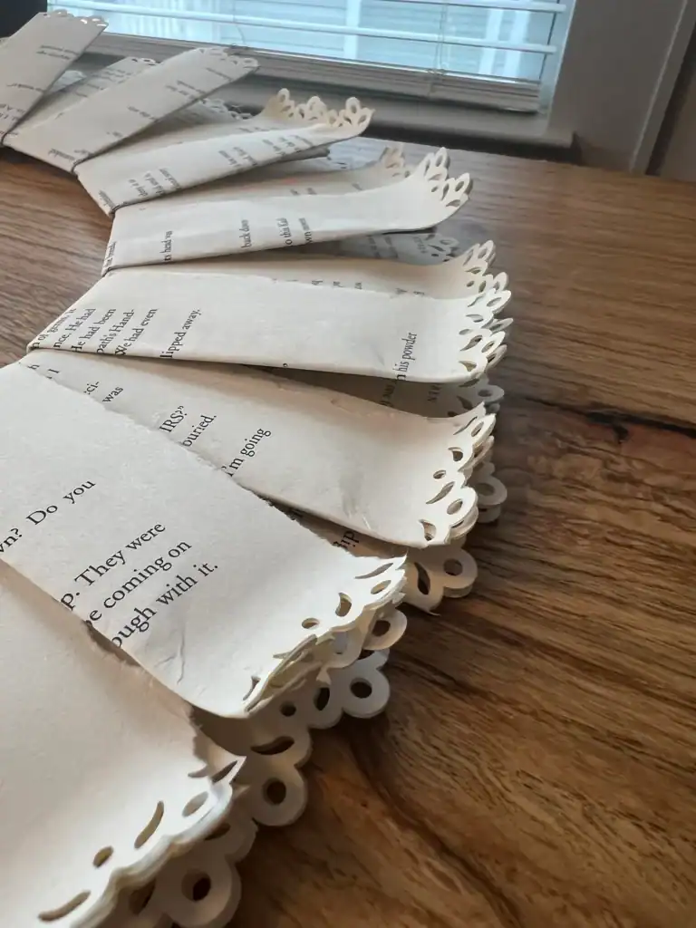 Curled decorative book page edges on a vintage paper wreath